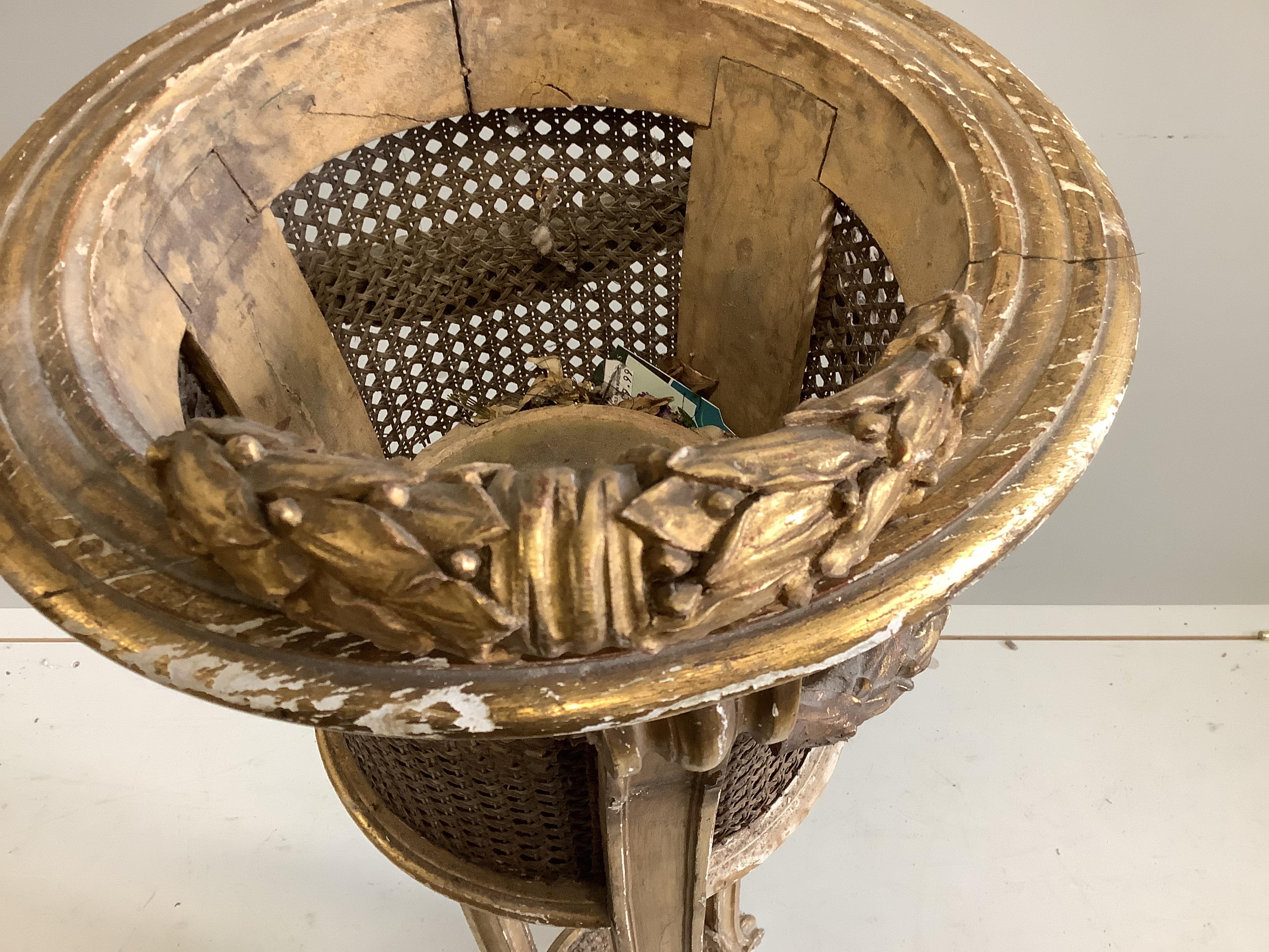 A carved giltwood and composition caned jardiniere stand, diameter 34cm, height 110cm (a.f.)